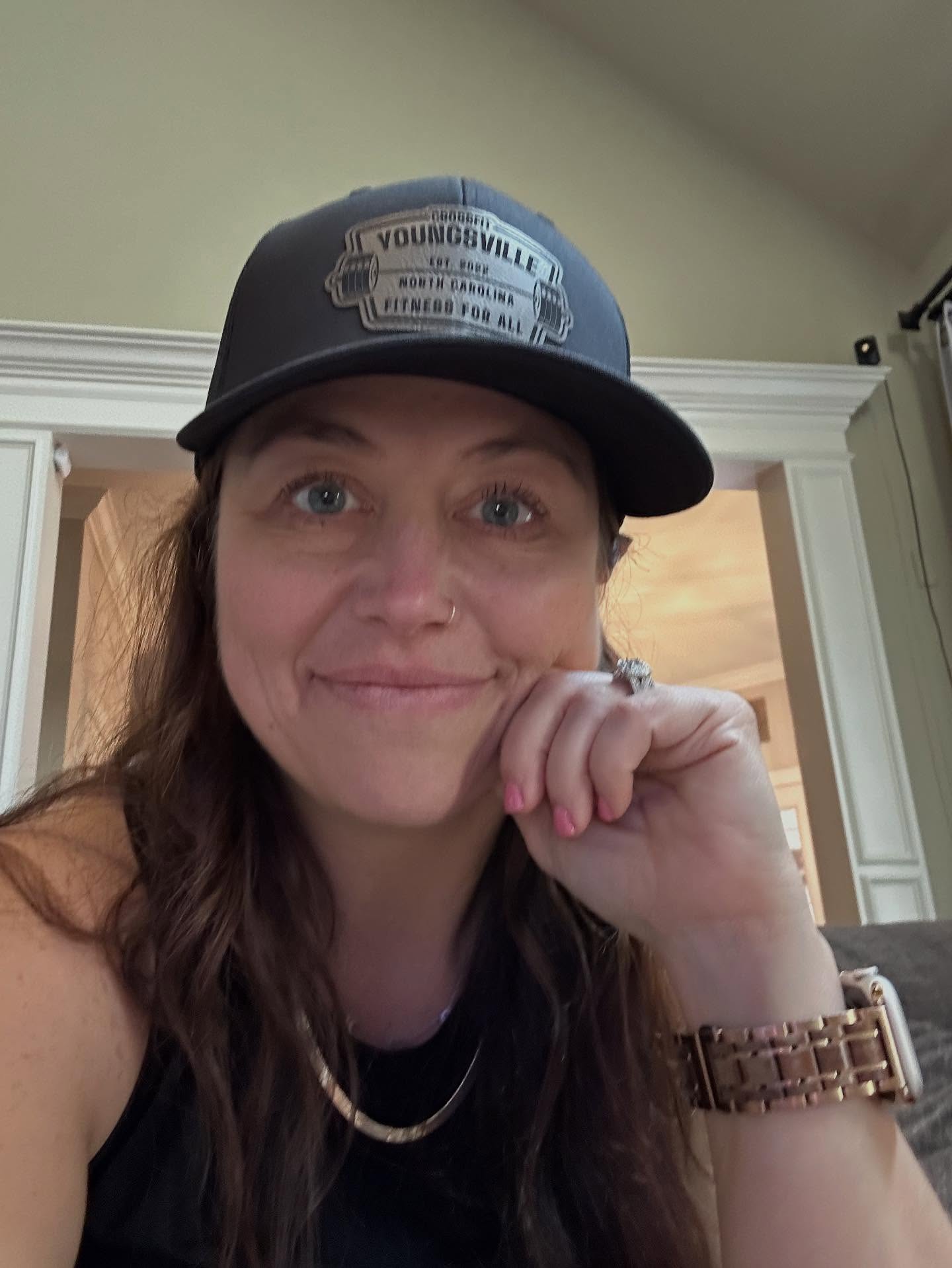 Martina in a CrossFit Youngsville hat at home